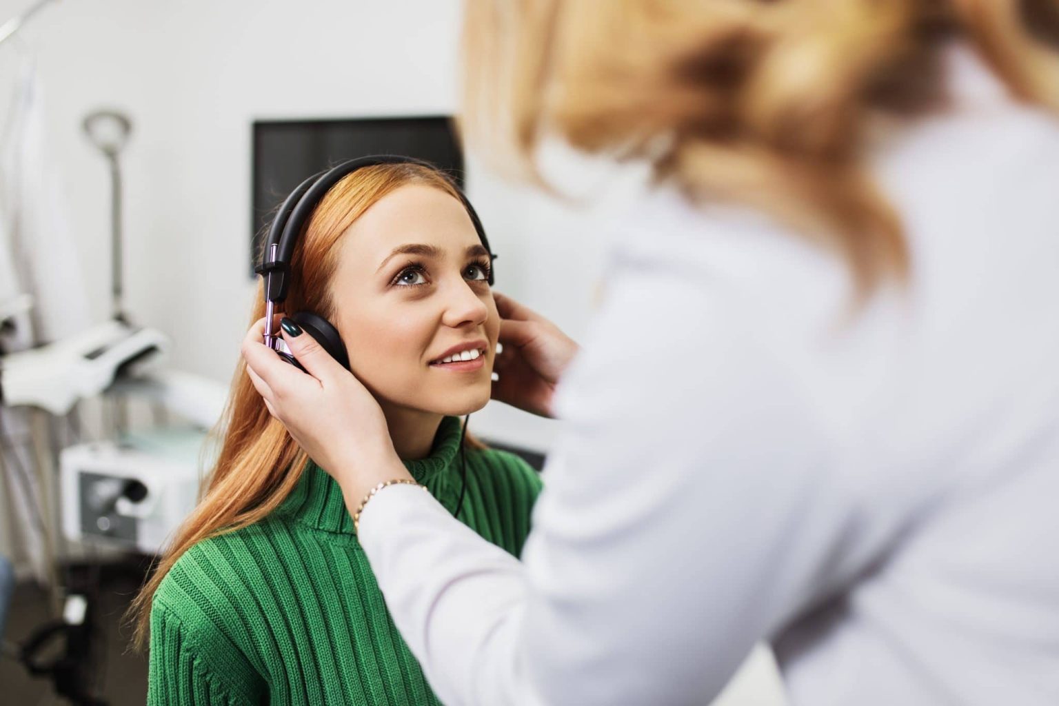 Woman gets a hearing test.