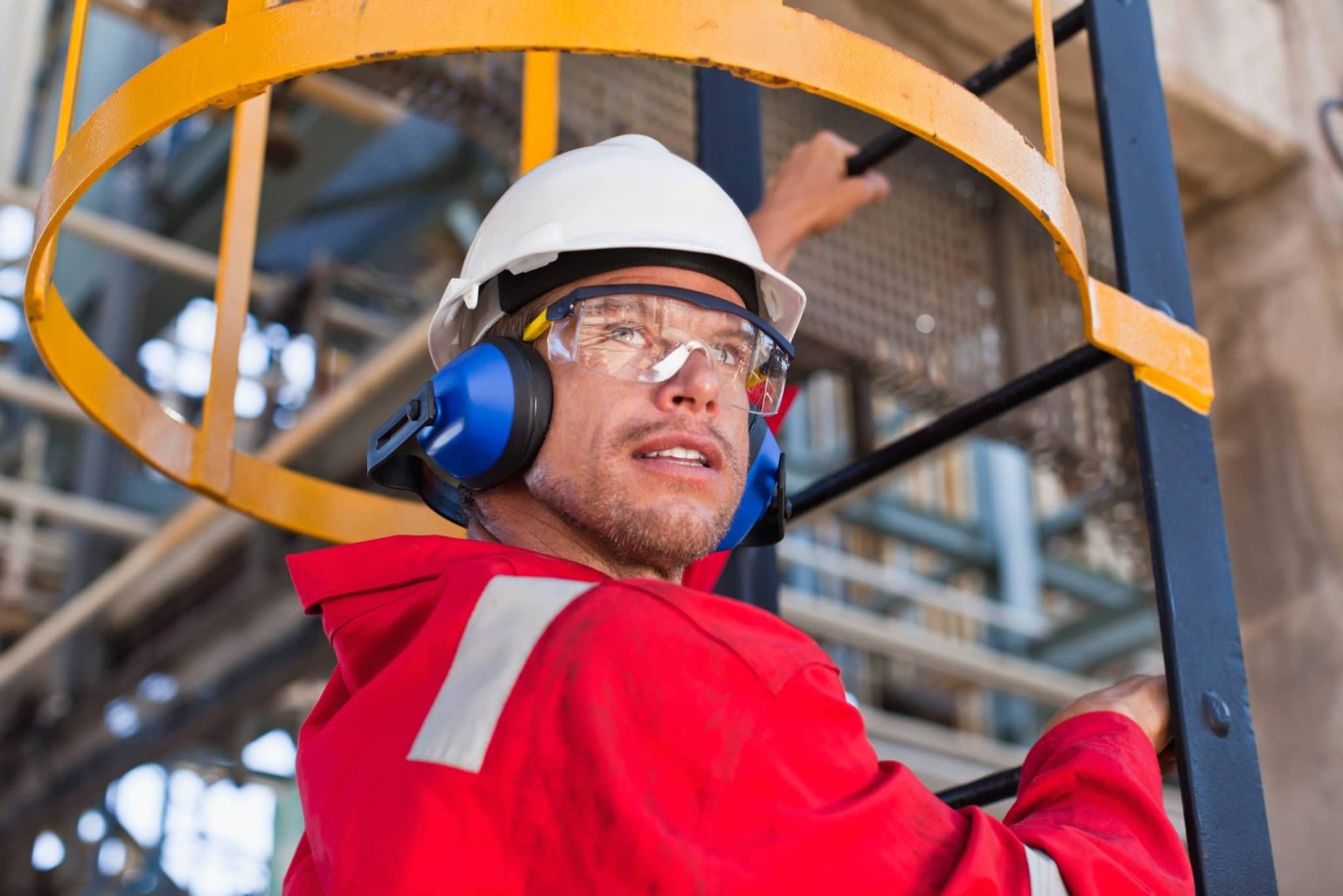 Worker with protective gear outside.