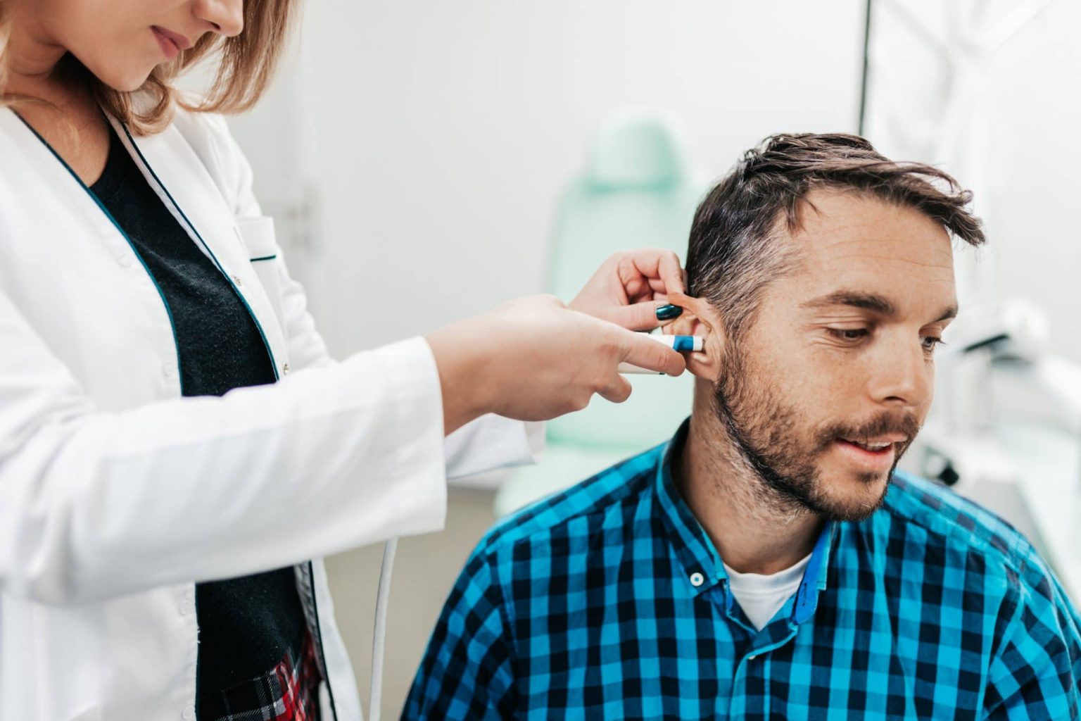 Middle age man at medical examination or checkup in otolaryngologist's office