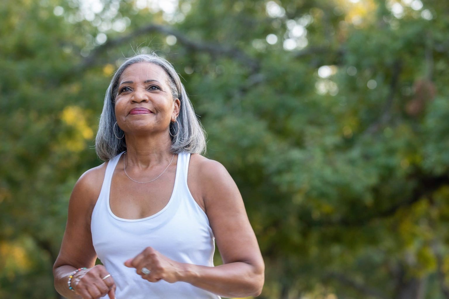 Older woman out walking in park.