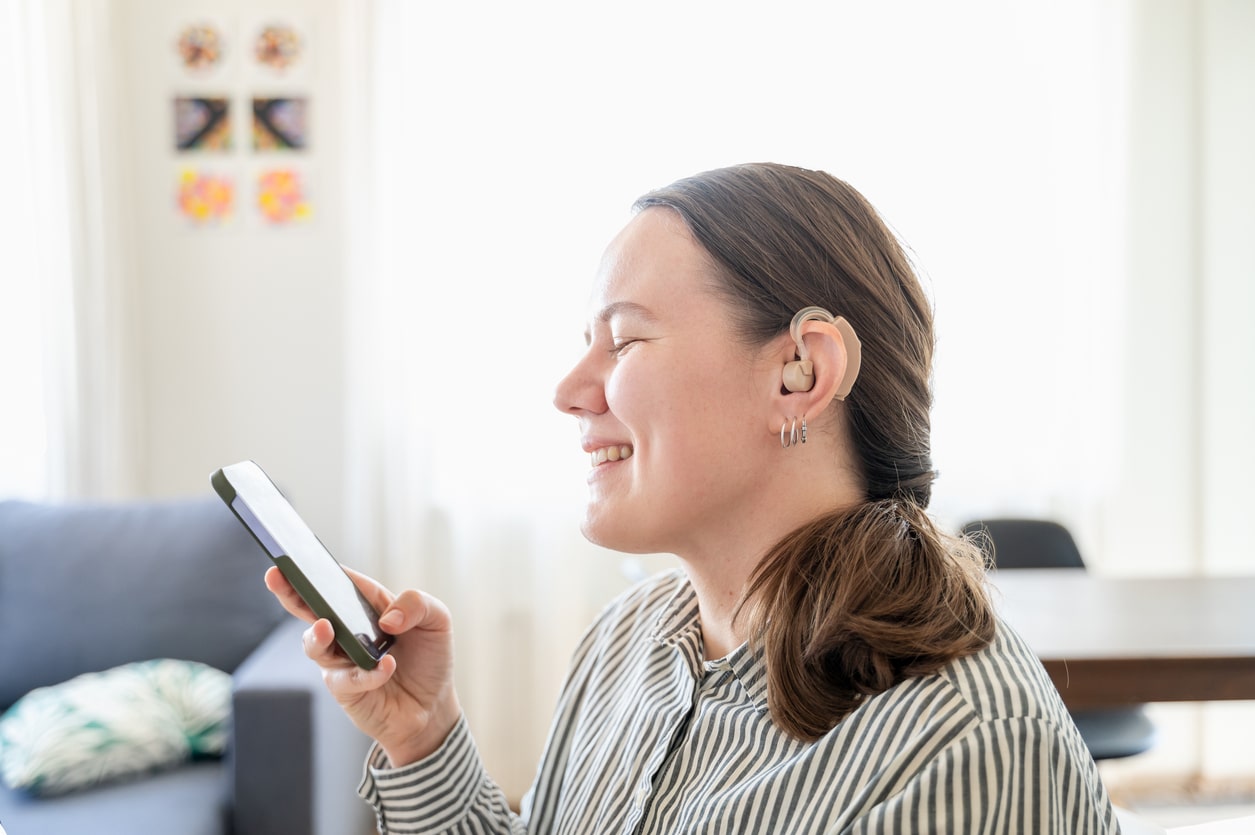 Happy woman with new hearing aids.